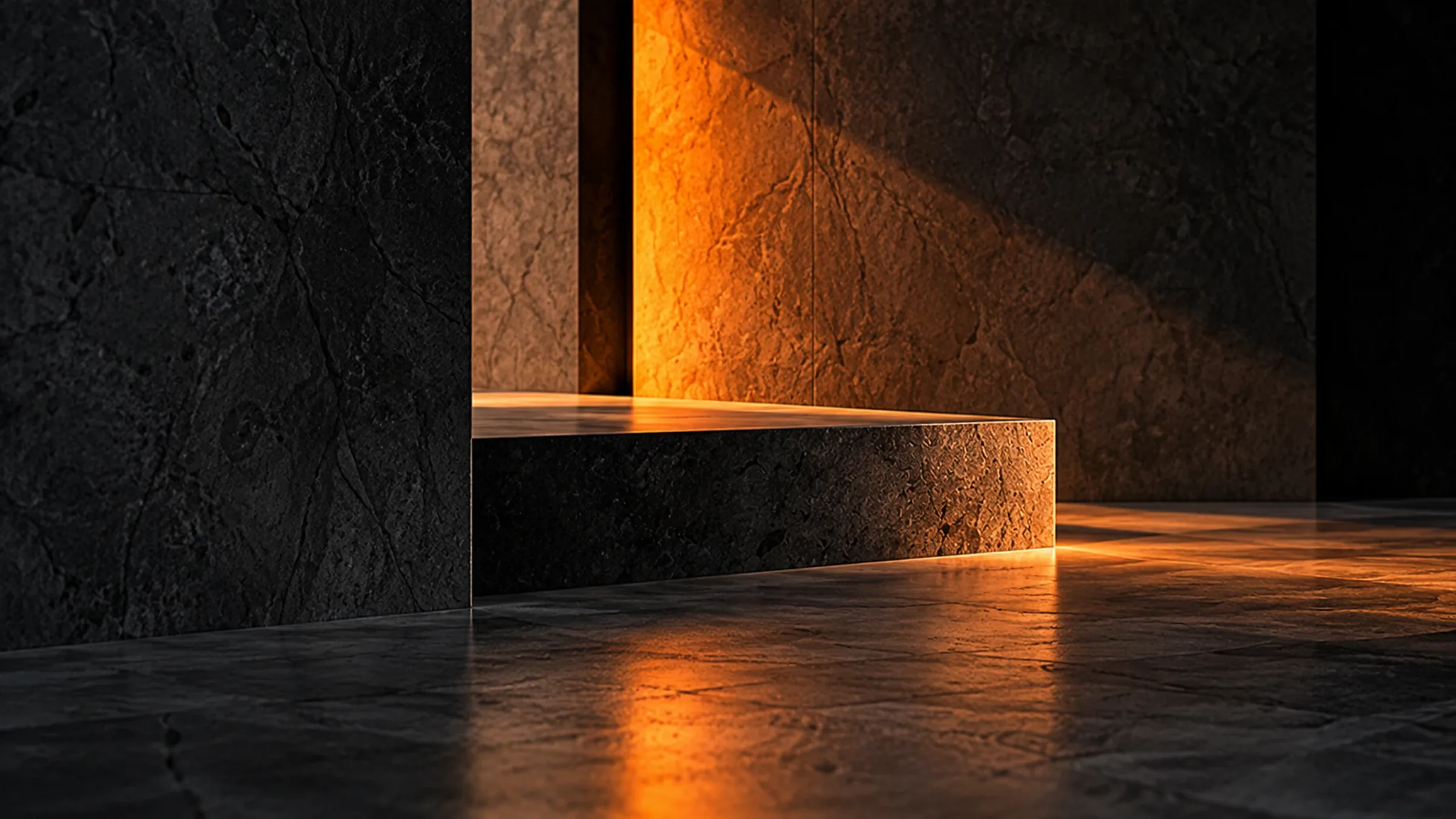 A dark stone plinth before a wall lit orange